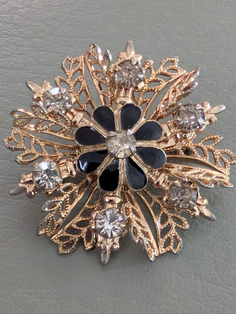 Gold-Tone Filigree Floral Starburst Brooch with Black Enamel and Clear Crystals